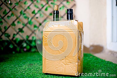 Alcohol in a cardboard box with beer and wine home delivered through online app shot in a garden at home Editorial Stock Photo