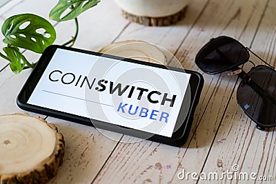 indian startup blockchain bitcoin altcoin app coinswitch kuber on a mobile phone on a wooden table showing this easy Editorial Stock Photo