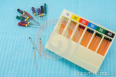 Gutta-percha pins in a set of different sizes for root canal filling, endodontic ruler close-up, material for endodontic Stock Photo