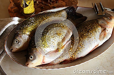 Gutted fish, sprinkled with spices Stock Photo