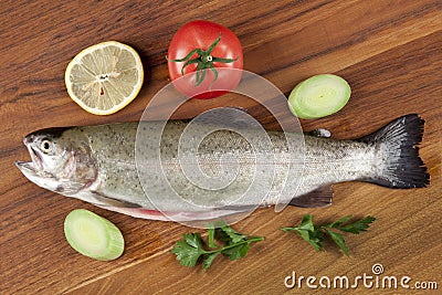 Gutted fish trout on a cutting board Stock Photo