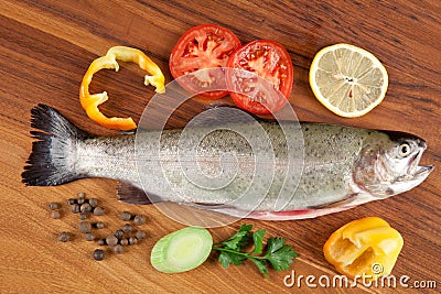 Gutted fish trout on a cutting board Stock Photo