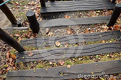 The gutter on the ridge helps pedestrians not to slip. terraces and paved slopes with stepped palisades and planks holding the sli Stock Photo