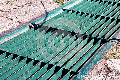 Gutters drain grate, drain cover. Road drains - sewer cover. iron grate of water drain on the road in every city. Water go down to Stock Photo