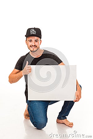 A guy with a beard posing with a white sign. Can be used for advertising, logo and business cards, contact phones, shares, etc. Stock Photo