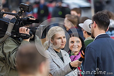 A guy being interviewed at the demonstration on Prague Wenceslas square against the current government and Babis Editorial Stock Photo