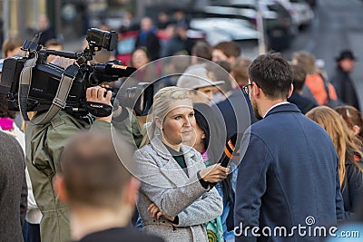 A guy being interviewed at the demonstration on Prague Wenceslas square against the current government and Babis Editorial Stock Photo