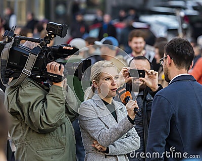 A guy being interviewed at the demonstration on Prague Wenceslas square against the current government and Babis Editorial Stock Photo