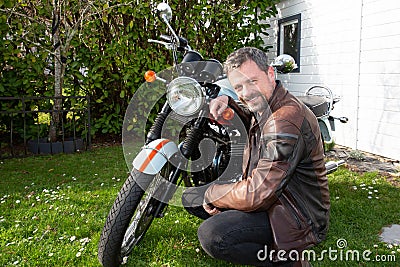 Guy biker hipster portrait handsome bearded man aside motorcycle neoretro classic bike Stock Photo