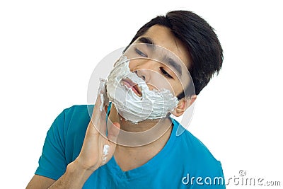 Guy with black hair head tilted to the side and rubs the foam Stock Photo