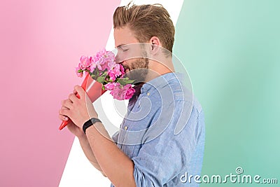 Guy bring romantic pleasant gift waiting for her. Man ready for date bring pink flowers. Boyfriend confident holds Stock Photo