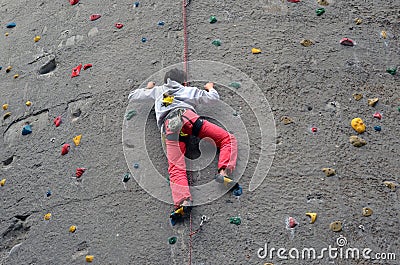 Guy climbing a public rock wall in Berlin Editorial Stock Photo