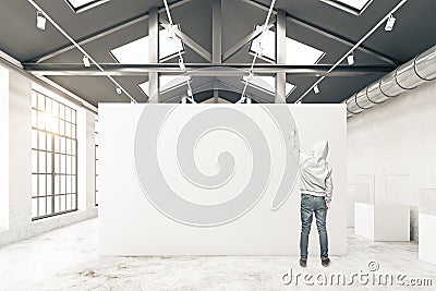 Guy drawing in warehouse interior Stock Photo