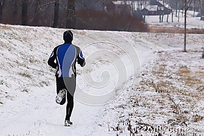 The guy is engaged in jogging in sportswear in the winter nature. Extreme weather conditions for sports and a healthy lifestyle. Editorial Stock Photo