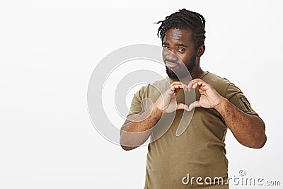 Guy always find way to women hearts. Good-looking flirty african-american in military t-shirt, showing heart gesture Stock Photo