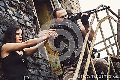 Guy with girl on a battlefield Stock Photo