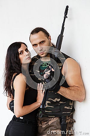 Guy with girl on a battlefield Stock Photo