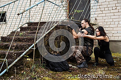 Guy with girl on a battlefield Stock Photo