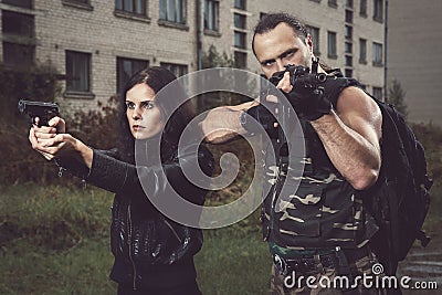 Guy with girl on a battlefield Stock Photo