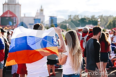 A guy with a girl with a Russian flag on the fan zone during the World Cup Editorial Stock Photo