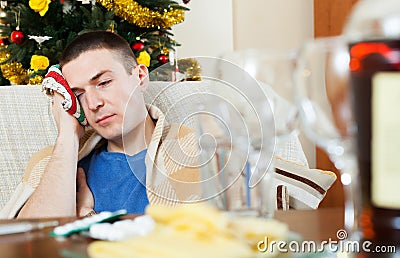 Guy having hangover after celebrating New year Stock Photo