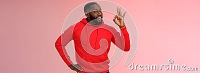 Guy hold everything under control assuring customer show okay sign. Portrait charismatic cheeky black bearded man say ok Stock Photo