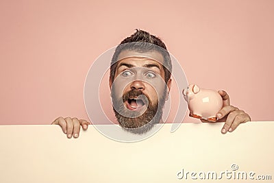Guy hold moneybox or piggy bank for savings. Stock Photo