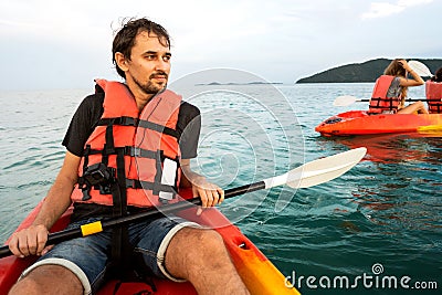 Guy kayaking at sunset on Bali Stock Photo