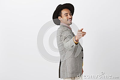 Guy knows how to find key to women hearts. Flirty confident dark-skinned heartbreaker in stylish clothes and black hat Stock Photo