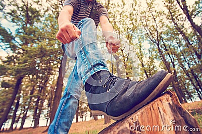 A guy lacing shoes, wide-angle photo, bottom view Stock Photo