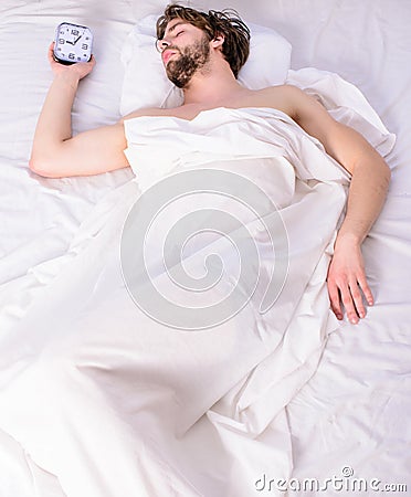 Guy lay under white bedclothes. Fresh bedclothes concept. Man sleepy drowsy unshaven bearded face covered with blanket Stock Photo