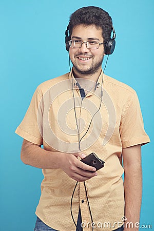 Guy listens to music on headphones Stock Photo