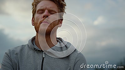 Guy looking at camera. Exhausted jogger feeling tired after cardio workout Stock Photo