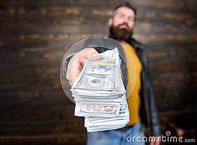 Guy mafia dealer with cash profit. Man give cash money bribe. Richness and wellbeing. Mafia business. Man brutal bearded Stock Photo