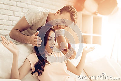 Guy Makes A Gift To Girlfriend On Valentine`s Day. Stock Photo