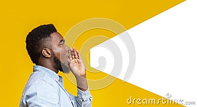 Guy making loud announcement at copy space on yellow background Stock Photo