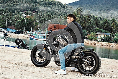 Guy on a motorbike on the beach Stock Photo