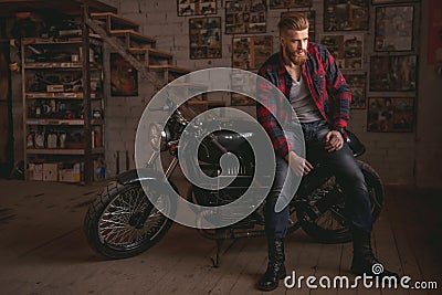 Guy in motorbike repair shop Stock Photo