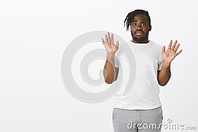 Guy is out of this shit. Anxious uninvolved funny plump dark-skinned guy in white t-shirt, raising palms in surrender Stock Photo