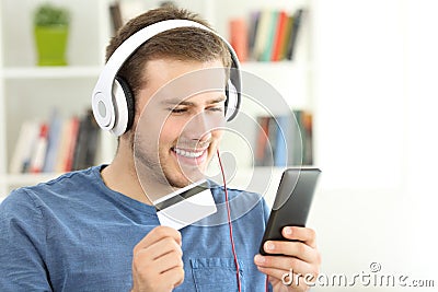 Guy paying streaming music with credit card Stock Photo