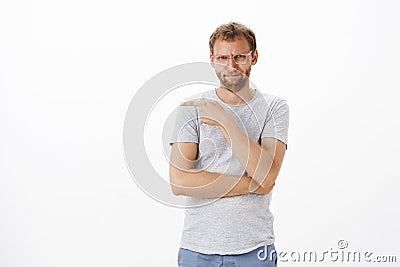 That guy me off. Portrait of intense bothered and irritated good-looking adult man with bristle in glasses Stock Photo