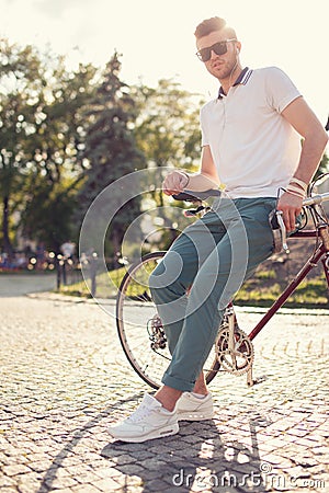 Guy posing with vintage race bike Stock Photo