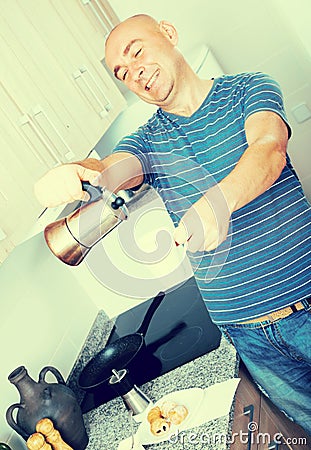 Guy pours coffee into cup of coffee pot Stock Photo