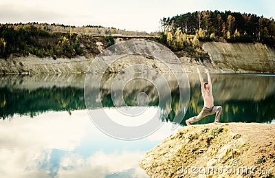 Guy practices asanas on yoga in harmony with nature Stock Photo