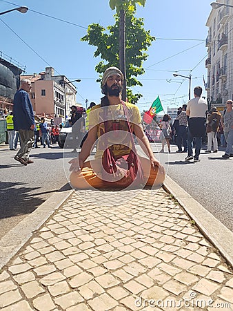 Guy praying for wellness of the workers in workers day in avenida almirante reis Editorial Stock Photo