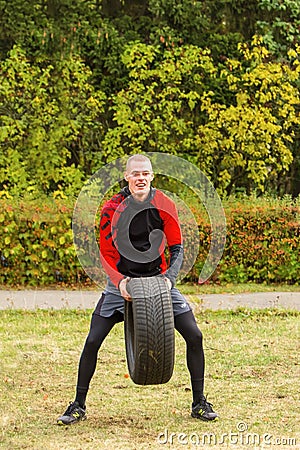 The guy raises the up tire. Editorial Stock Photo