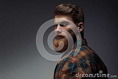 Guy with a red beard in a plaid shirt Stock Photo