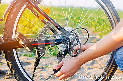 The guy repairs the bicycle. chain repair. cyclist. unratitude o Stock Photo