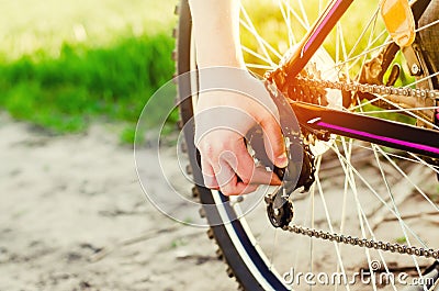 The guy repairs the bicycle. chain repair. cyclist. unratitude on the road, travel, close-up Stock Photo