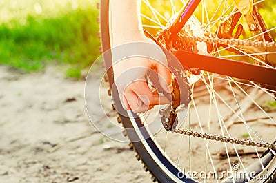 the guy repairs the bicycle. chain repair. cyclist. unratitude on the road, travel, sports, close-up Stock Photo